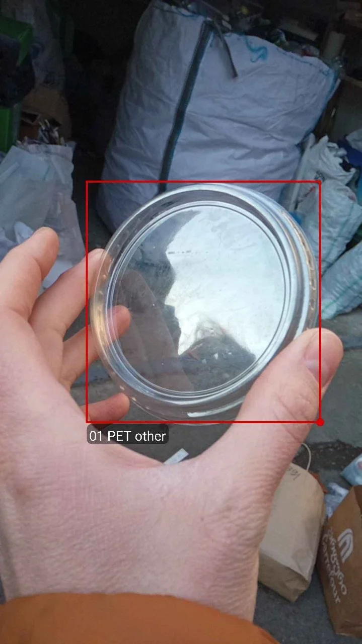 Plastic PET container held in hand, app recognition box labelled 01 PET other